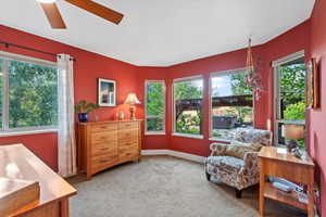 Living area with carpet flooring and ceiling fan