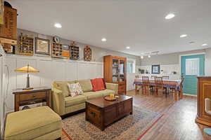 Living room featuring rail lighting and wood-type flooring