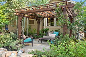 View of patio with a pergola and an outdoor hangout area