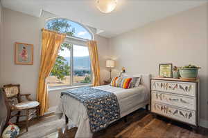 Bedroom featuring wood-type flooring and a mountain view