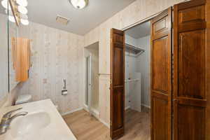 primary suite bath with walk-in closet