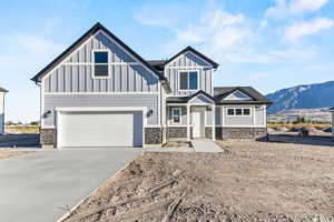 View of front of house with a mountain view and a garage