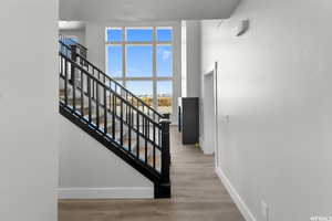 Stairway featuring hardwood / wood-style flooring