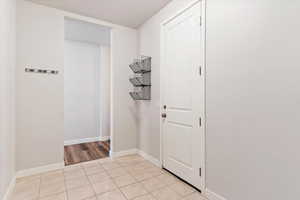 Mud Room off Garage Entrance: Corridor with light tile patterned floors