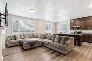 Living room featuring light hardwood / wood-style flooring and a textured ceiling