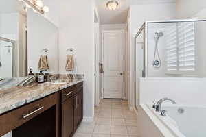 Primary Bath: Bathroom with independent shower and bath, vanity, and tile patterned flooring