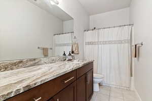 Guest Bath: Bathroom with toilet, tile patterned floors, and vanity