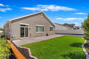 Back of property with a patio and a yard