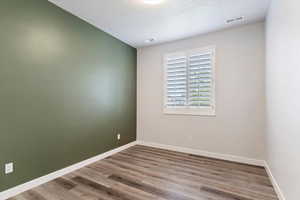 Guest Bedroom 2: Empty room featuring a textured ceiling and wood-type flooring