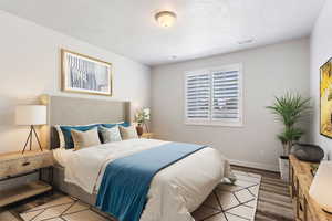 Primary Bedroom with wood-type flooring and a textured ceiling - Virtually Staged