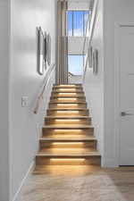 Stairway featuring wood-type flooring