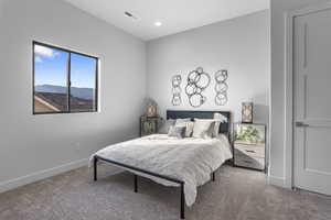 Carpeted bedroom with a mountain view