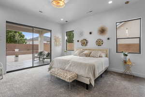 Bedroom with access to exterior, carpet floors, and multiple windows