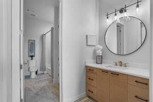 Full bathroom featuring vanity, toilet, and shower / bath combo with shower curtain