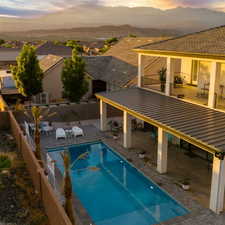 Pool at dusk featuring a patio