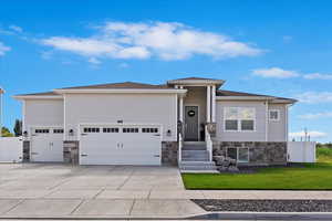 View of front of house with a front lawn and a garage