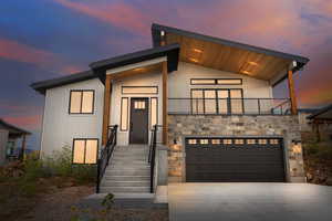 Contemporary home with a garage and a balcony