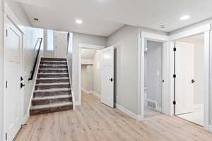 Stairs with hardwood / wood-style floors