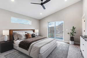 Carpeted bedroom featuring lofted ceiling, ceiling fan, and multiple windows