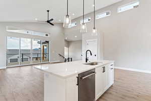 Kitchen with ceiling fan, white cabinets, dishwasher, light wood-type flooring, and sink