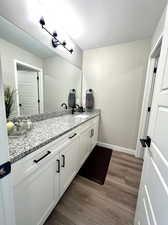 Bathroom with hardwood / wood-style floors, a textured ceiling, and vanity