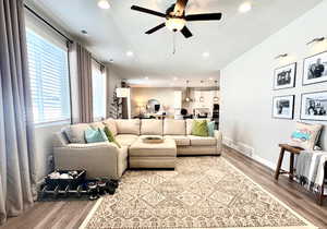 Living room with ceiling fan and light hardwood / wood-style flooring