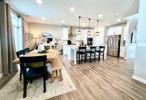 Dining area featuring light wood-type flooring and sink