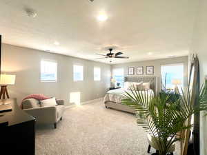 Bedroom featuring ceiling fan and carpet