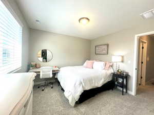 Bedroom featuring light carpet