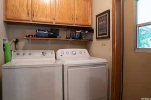 Clothes washing area with washing machine and dryer and cabinets