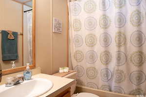 Full bathroom featuring shower / bath combo, toilet, and vanity