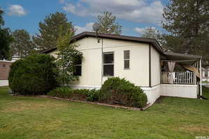 View of side of home with a lawn