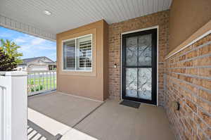 Front covered patio, storm door, ring doorbell, front entry door.