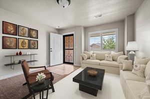 Virtual Living room featuring a textured ceiling, light carpet, natural light