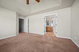 Primary bedroom with ceiling fan, ensuite bathroom with double doors for wheelchair access, and light carpet