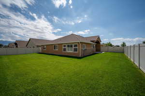 Large Back of house featuring a back and sideyard