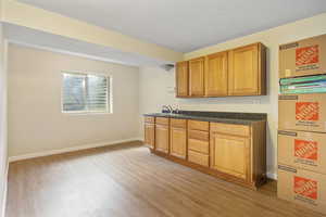 Kitchen with sink and light hardwood / wood-style flooring