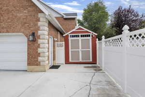 Exterior space featuring a patio area and a shed