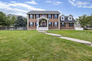 Colonial-style house with a front yard