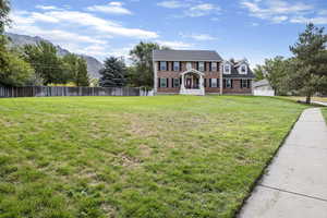 Exterior space with a front lawn and a mountain view