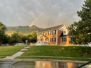 Colonial inspired home featuring a front yard and a mountain view