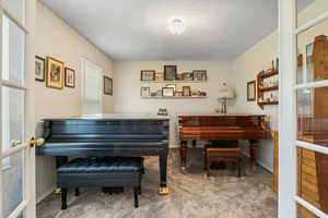 Misc room featuring light colored carpet