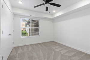 Carpeted spare room with ceiling fan