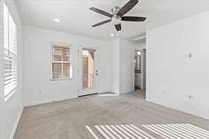 Carpeted spare room with ceiling fan