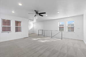 Spare room with ceiling fan and light colored carpet