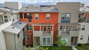 Rear view of house featuring a mountain view and a balcony