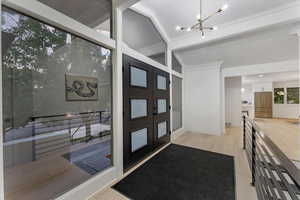 Entrance foyer featuring a wealth of natural light, an inviting chandelier, and light hardwood / wood-style floors