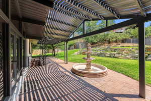 View of patio / terrace featuring a pergola and a storage shed