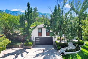 View of front of house featuring a mountain view and a garage