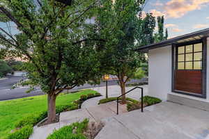 Patio terrace at dusk featuring a yard